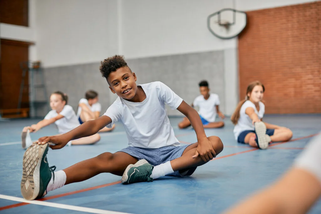 Students learning proper movement techniques to prevent injuries in physical education class
