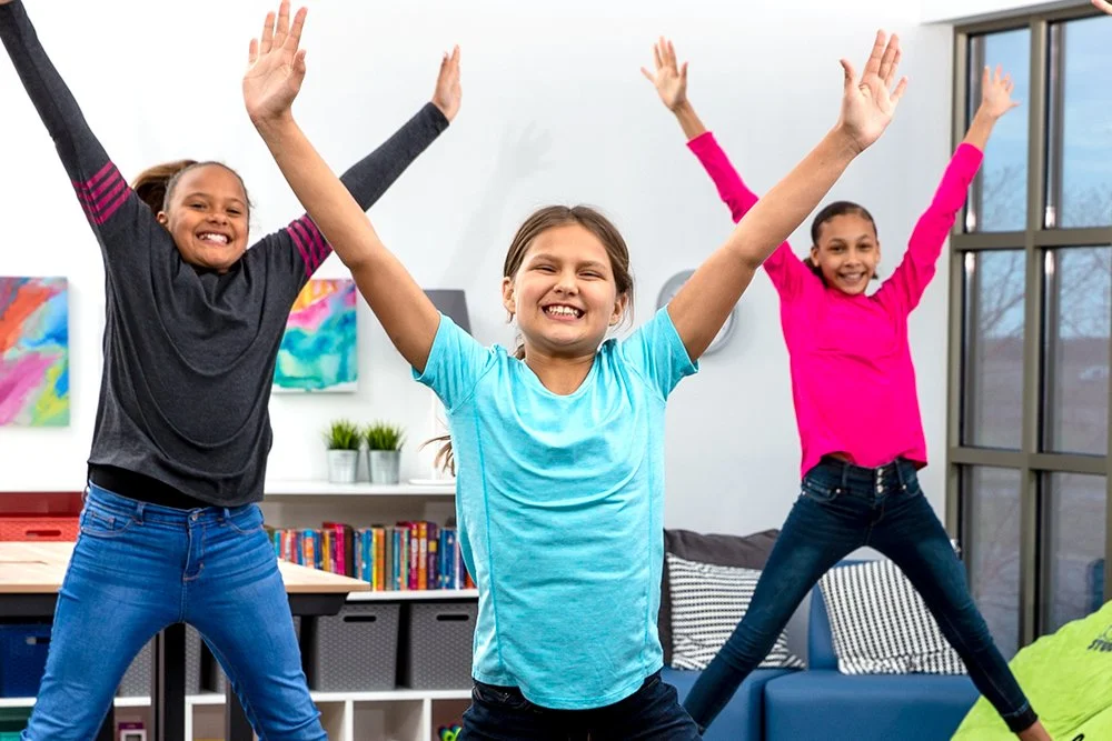 Students practicing physical education skills in an active classroom setting